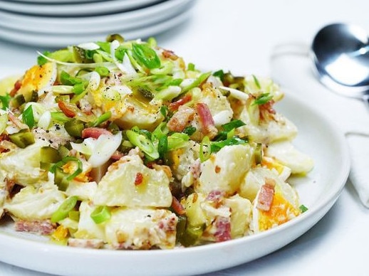 The secret to the success of this potato salad recipe is fried bacon and crispy onions.