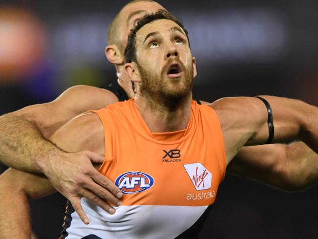 Shane Mumford of the Giants (front) and Tom Bellchambers of the Bombers contest during the Round 15 AFL match between the Essendon Bombers and the GWS Giants at Marvel Stadium in Melbourne, Thursday, June 27, 2019. (AAP Image/Julian Smith) NO ARCHIVING, EDITORIAL USE ONLY