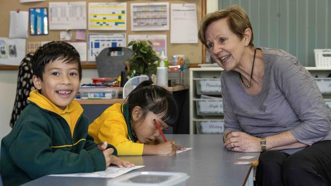 Teacher Anita Hudd with Reception students Pranish, 6, and Abigail, 5. Mrs Hudd has spent 50 years teaching in SA primary schools. Picture: Kelly Barnes