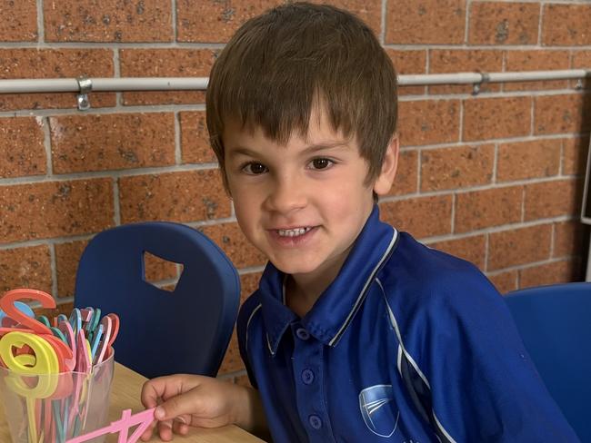 Benji sitting at his desk at Australian Christian College in Casey. Picture: Supplied