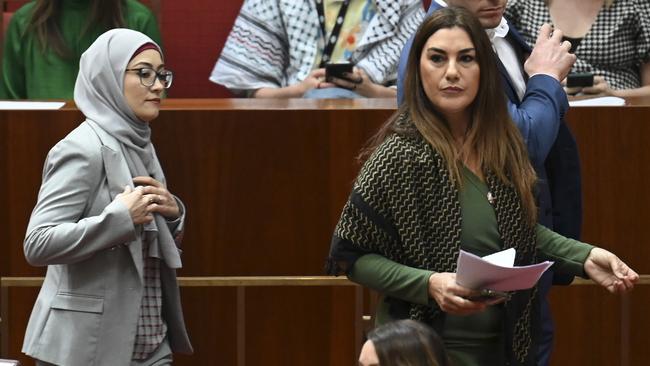 Ms Payman (left) crosses the floor to support Greens Senator Mehreen Faruqi’s motion to have the Senate recognise Palestine as a state. Picture: Martin Ollman