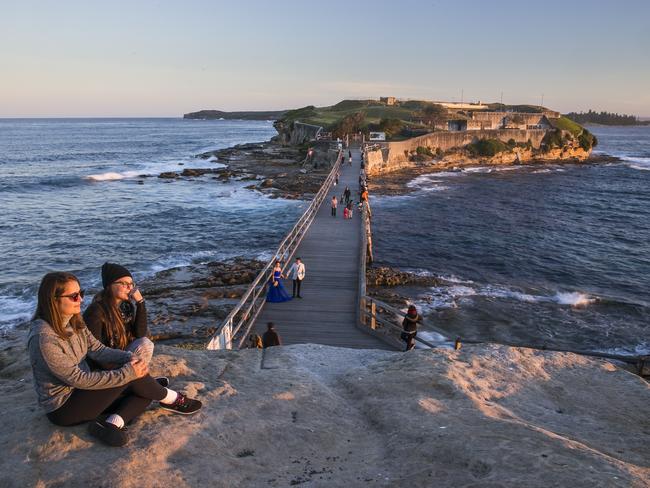 Friends Tainara Sassi and Luisa Bombarda at Bare Island, La Perouse, during sunset. Picture: Dylan Robinson