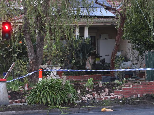 MELBOURNE, AUSTRALIA - NewsWire Photos - 03 JULY, 2024: A driver has been killed in a collision with a stolen car in Burwood. Damage to the front fence of a house that one of the cars crashed through. Wednesday, July 3, 2024. Picture: NewsWire / David Crosling