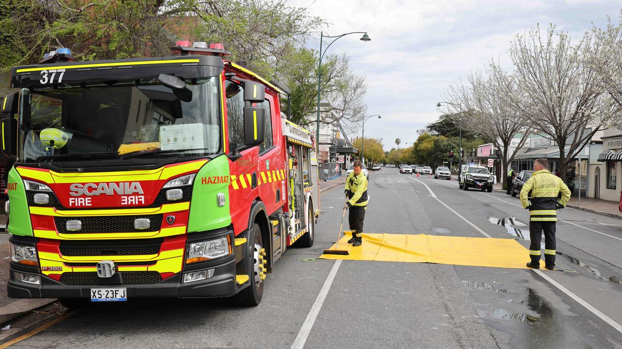 Firefighters mop up after the blaze. Picture: Ben Clark