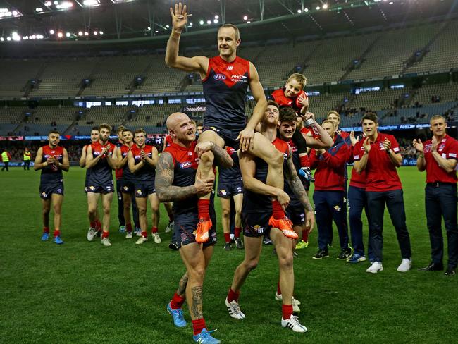 Daniel Cross is chaired off the ground after his final AFL match. Picture: Colleen Petch.