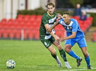 CLOSE CONTROL: South West Queensland Thunder striker Travis Cooper (right) attempts to work his way past Western Pride's Nielen Brown. Picture: Nev Madsen