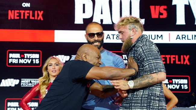 Mike Tyson laid hands on Jake Paul as they faced off. (Photo by TIMOTHY A. CLARY / AFP)