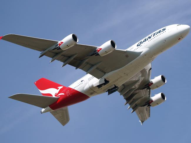 "Sydney, Australia - March, 14th 2012: Quantas aeroplanes and tail fin with the distant view of downtown Sydney - Sydney Airport"