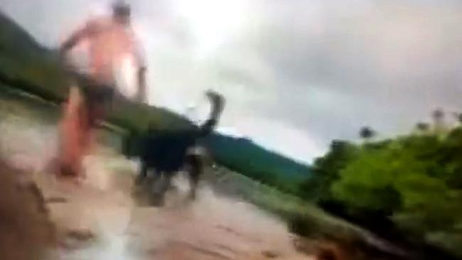 Video still of Alister MacPhee and his dog being attacked by a crocodile near the Bloomfield boat ramp in North QLD.