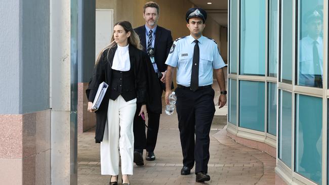 Crown prosecutor Claudia Georgouras leaves the Cairns District Court with Senior Constable Saurabh Verma and another police officer (back) after Mr Verma gave evidence. Picture: Brendan Radke