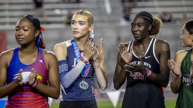 AB Hernandez, centre, claps with Kira Gant Hatcher, right, during a medal ceremony for the triple jump at the California high school track-and-field championships in Clovis, Calif., Saturday, May 31, 2025. Picture: Stephen Lam/San Francisco Chronicle via AP