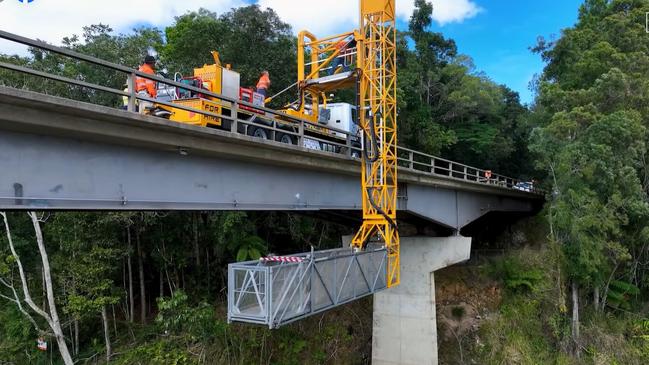 Roadtek employees work on the underside of the Barron River bridge at Kuranda. Picture: TMR