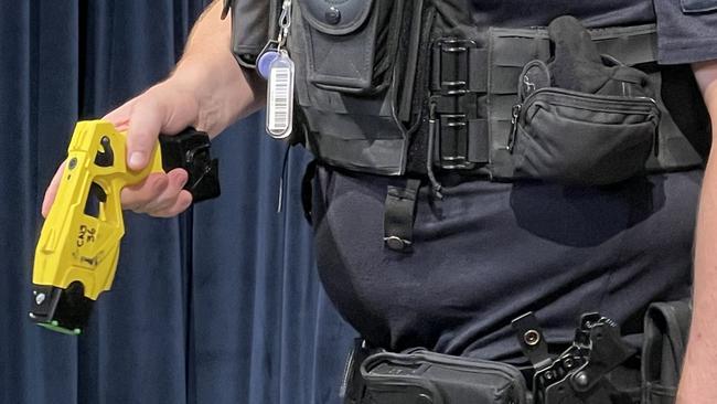 A police officer demonstrates a taser.