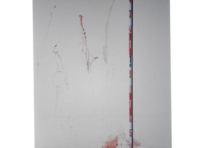 A tape measure records the size of blood stains on a wall. Picture: Supreme Court of NSW