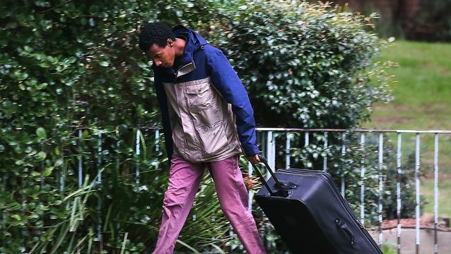 A man with a suitcase outside one of the towers. Picture: Ian Currie