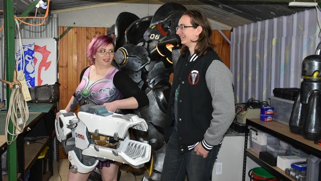 Clare "Henchwench" McCutcheon and Oarin "Scrap Shop Props" Tremont with two of their biggest works, Zarya’s particle cannon and Reinhardt’s armour from <i>Overwatch</i>. Picture: <a href="https://www.facebook.com/minxysmayhem/" title="www.facebook.com">Minxy’s Mayhem</a>