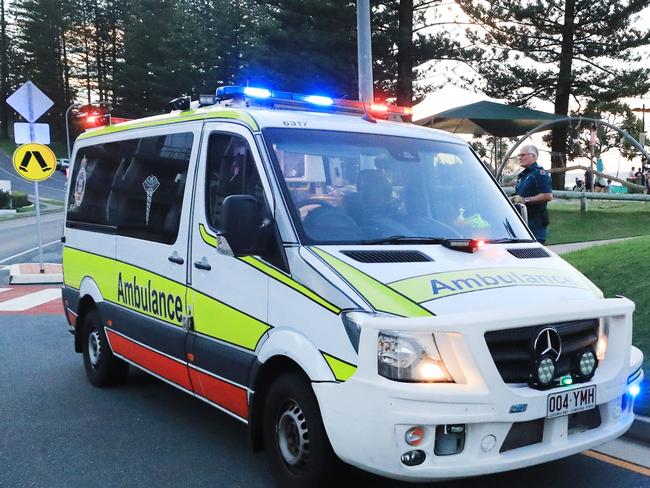 March 13, Rainbow Bay, Coolangatta, Gold Coast - Queensland Ambulance Officers interview witnesses to a mistaken report of a shark attack which turned out to be a self inflicted Surfing Fin Chop.Picture Scott Powick Newscorp