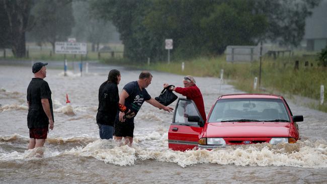 The driver was rescued by locals as it is inundated with flood water. Picture: Nathan Edwards