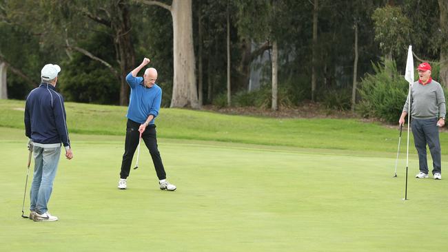 Rob Taylor makes a birdie putt on the 9th hole at Ringwood Golf Course during a game with friends this morning. Picture: Hamish Blair