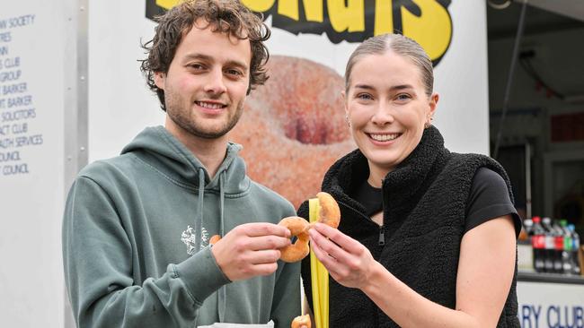 Tyler Ritzau and Hannah Paech-McMahon enjoy some cinnamon doughnuts. Picture: Brenton Edwards