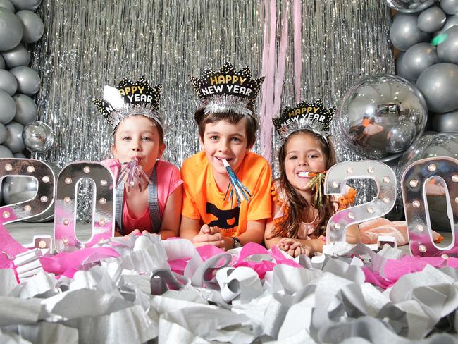 Madeleine Daley, 6, Mason Daley, 6, and Georgina Neil, 5, pose at Portside Wharf, Brisbane on Tuesday, December 18, 2019. Photo: Claudia Baxter