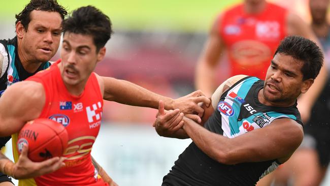 Jake Neade attempts to tackle Alex Sexton during Saturday’s game in Shanhai. Picture: AAP Image