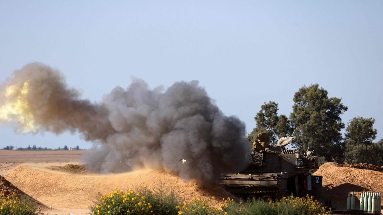 An Israeli mobile artillery unit fires a shell from a border position in southern Israel toward the Gaza Strip on May 8, 2024, amid the ongoing conflict in the Palestinian territory between Israel and the Hamas movement. (Photo by JACK GUEZ / AFP)