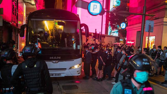 Hong Kong police load protesters on to a bus on Wednesday night. Picture: AFP