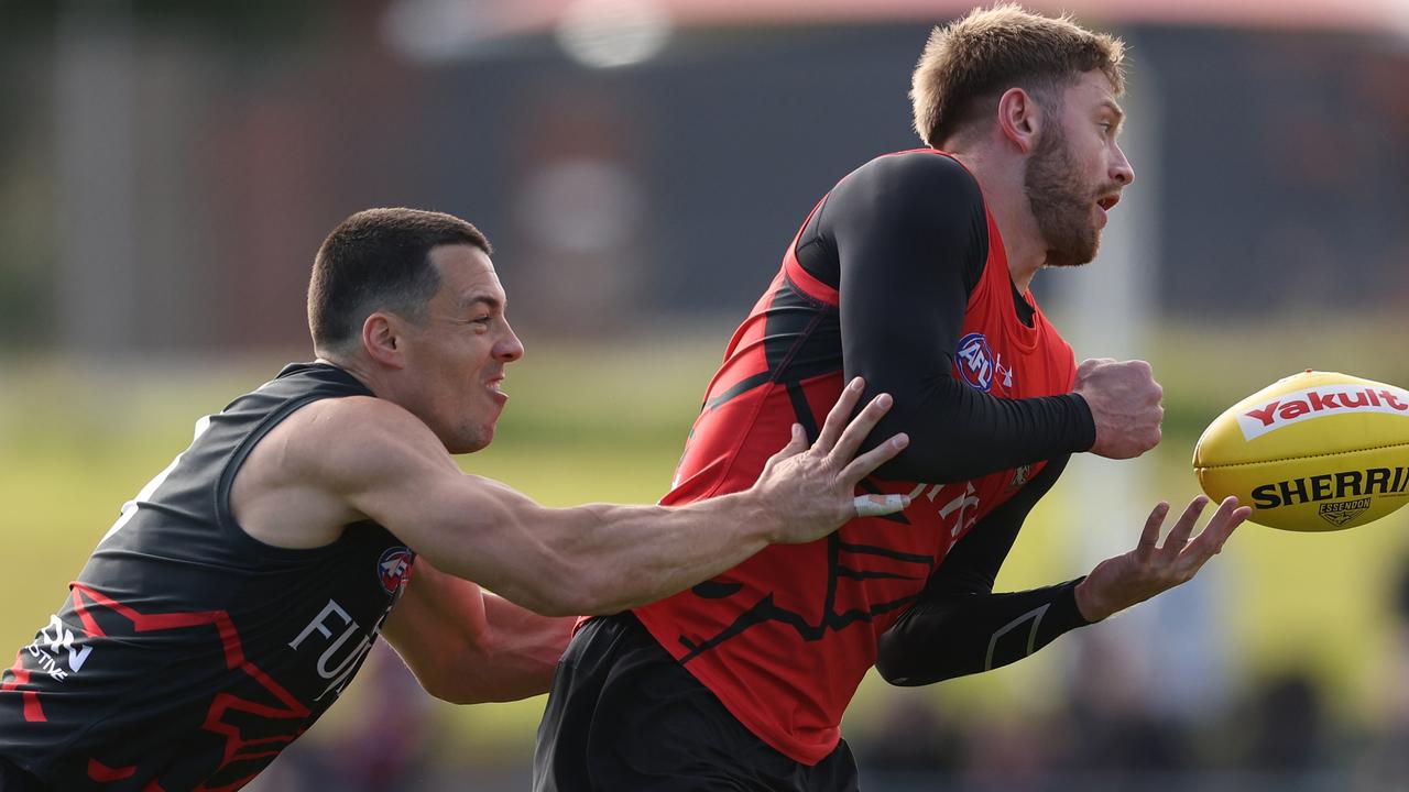 Dylan Shiel (left) tackles Jayden Laverde at Essendon training on Wednesday. Picture: Robert Cianflone / Getty Images