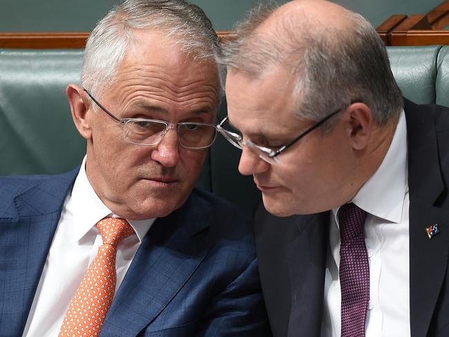 Australian Prime Minister Malcolm Turnbull and Australian Treasurer Scott Morrison confer while listening to the speech on Thursday night. Picture: AAP Image/Lukas Coch