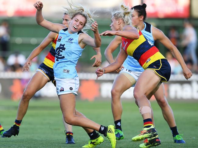 Adelaide’s Erin Phillips tackles Carlton’s Sarah Hosking.