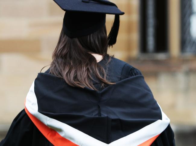 University students wearing their graduation mortar board hats and gowns for their graduation ceremony on campus at Sydney University in Sydney.