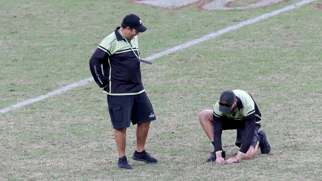 Groundsmen repairing the turf at Suncorp 