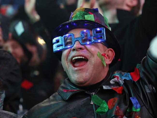 A reveler celebrates as confetti falls in New York's Times Square. Picture: AP