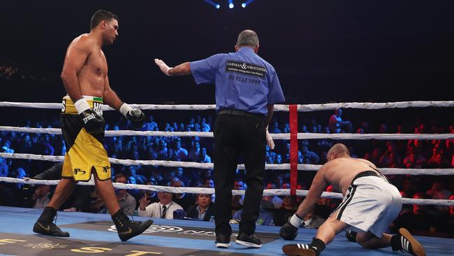 Justin Hodges looks on as opponent Troy McMahon struggles to his feet. Picture: Brett Costello