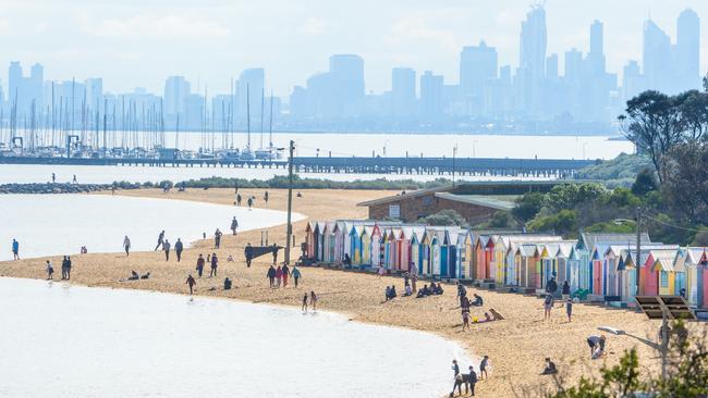 People can be seen sunbaking at Brighton on Saturday. Picture: Jay Town