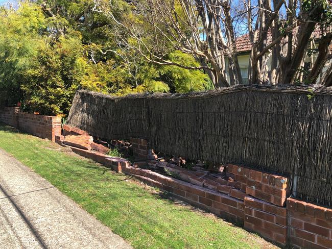 A damaged brick boundary fence at the home of Pam Ridden at the intersection of Pringle and Haigh avenues at Belrose. Picture: Jim O'Rourke