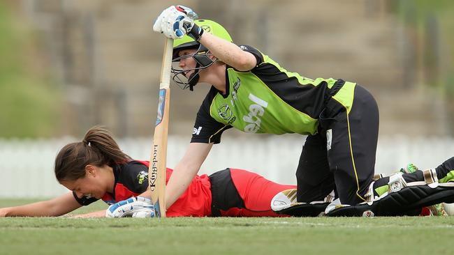 Alex Blackwell of the Thunder and Molly Strano of the Renegades watch on during the WBBL match between the Melbourne Renegades and Sydney Thunder at Blacktown International Sportspark.