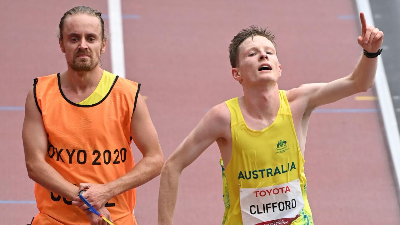 Australia’s Jaryd Clifford and his guide cross the finish line.