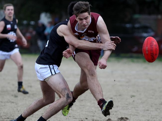 Andrew Padbury gets a kick away under pressure last year. Picture: Mark Dadswell/AAP