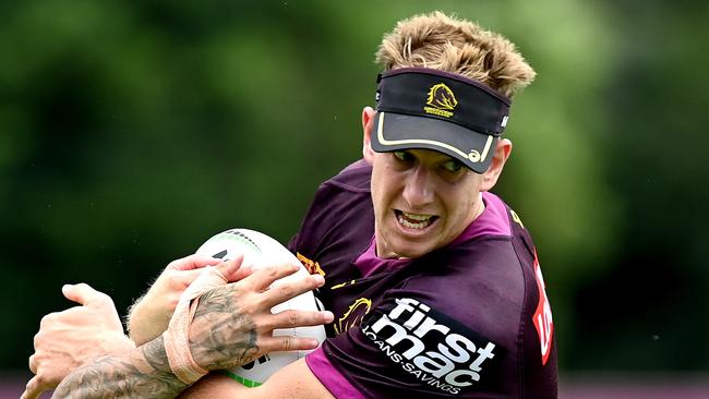 Zac Hosking takes on the defence during a Brisbane Broncos NRL training session at the Clive Berghofer Centre in Brisbane (Photo by Bradley Kanaris/Getty Images)