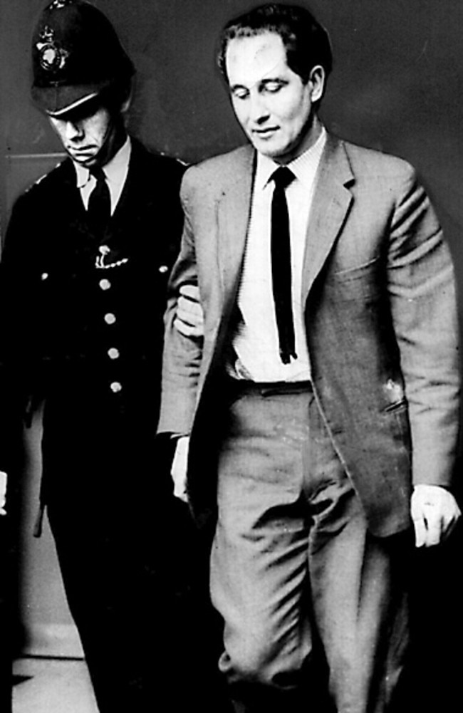 Ronald Biggs is escorted by police into a court hearing in London in 1965.