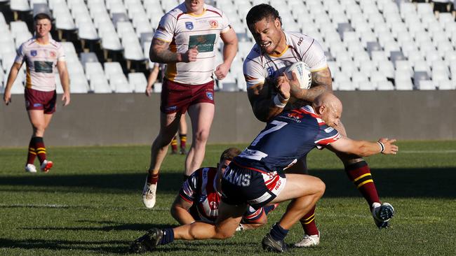 Thirlmere's Jacob Loko is tackled by Camden’s Brad Speechley. Picture: John Appleyard