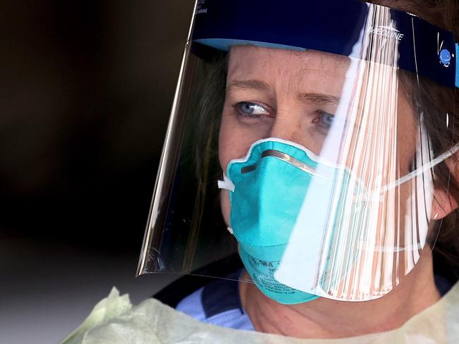 Dawn Canova, clinical manager for outpatient wound care prepares to take samples from people so to test them for the coronavirus at a drive-thru station in the hospital's parking garage, Picture: AFP