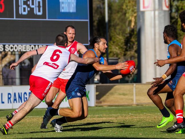 Cameron Ilett evades a pack of Demons players while playing for Rovers in the CAFL. Picture: Charlie Lowson