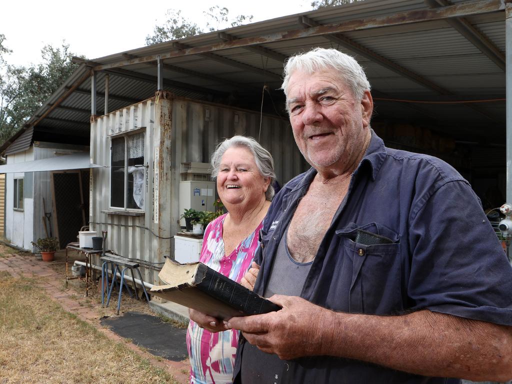 Paster Ron Evans holding his Bible with his wife Edna Evans on their block outside of Tara. Picture: Liam Kidston