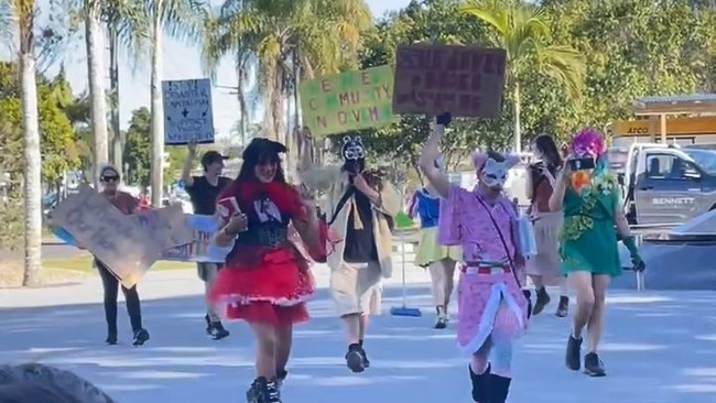 Costumed protesters crash a Lismore flood recovery press conference on Tuesday afternoon. Picture: Savannah Pocock