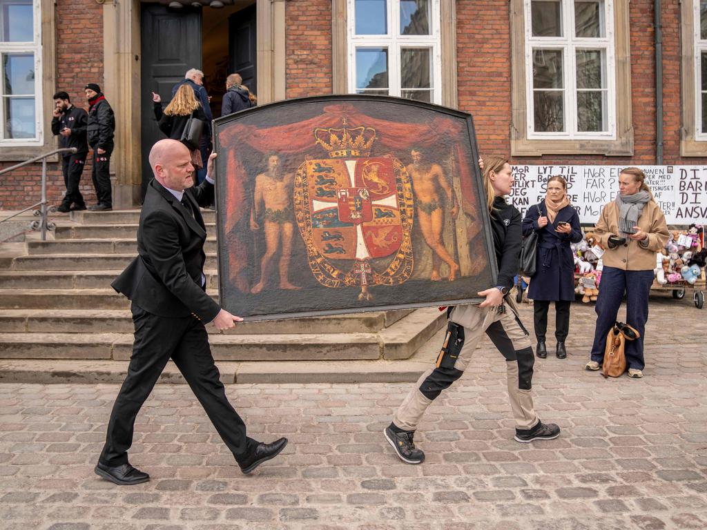 People carry historical paintings out of the burning building, as the Stock Exchange burns in Copenhagen, Denmark. Picture: Ritzau Scanpix / AFP