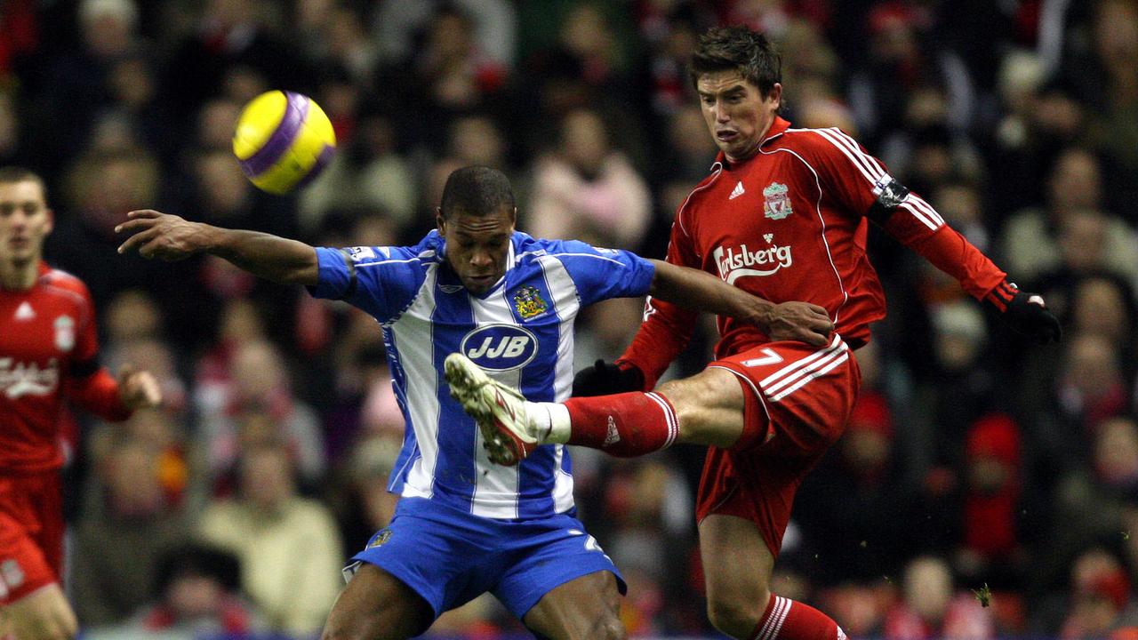 Wigan’s Marcus Bent faces off with Liverpool’s Harry Kewell.