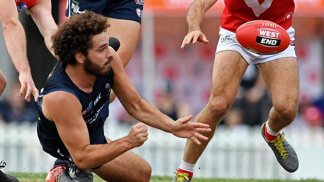 South Adelaide’s Abe Davis gets a handball away. Picture: Tom Huntley